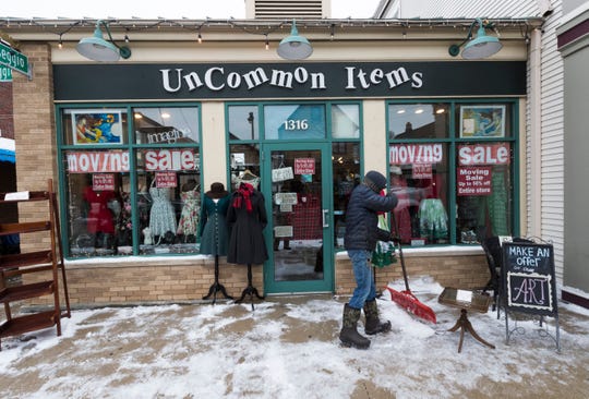 Snow is removed from the sidewalk Tuesday at Uncommon Items, 1316 E. Brady St. The store is set to close on Brady Street on Jan. 5 and move to a shared space in Walker's Point in the next few weeks.