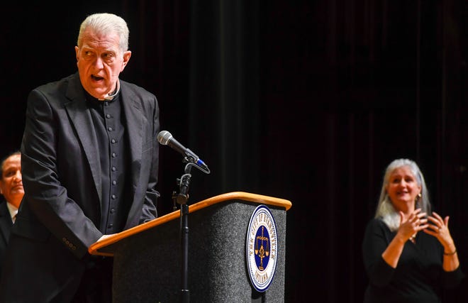The Rev. Kevin Fleming jokingly admonishes the officials "that if it doesn't work out, it's not God's fault" during a 2020 swearing-in ceremony for Evansville city government officials. Fleming died Saturday at age 64.