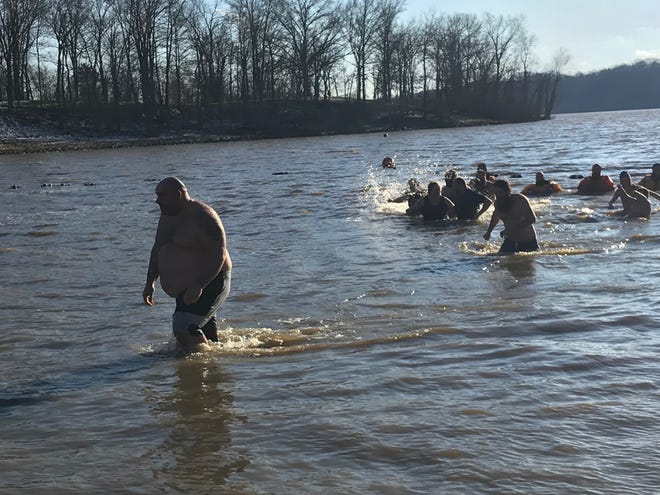 Hundreds of people jumped into Charles Mill Lake on New Year's Day for the annual Polar Bear Dip.