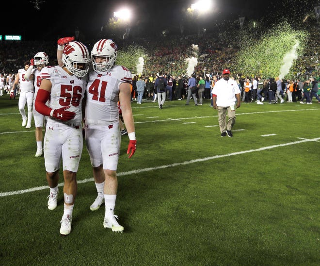 Wisconsin linebackers Zack Baun (56) and Noah Burks (41) walk off the field after losing the Rose Bowl to Oregon, 28-27.