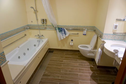 Grand Suite bathrooms have a whirlpool tub. The pictured Grand Suite bathroom has been modified for wheelchair access.