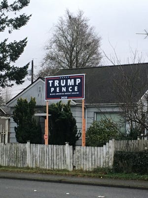 The city of Bremerton said the 15-foot Donald Trump sign in Kevin Chambers' yard exceeds the maximum height allowed under city regulations.