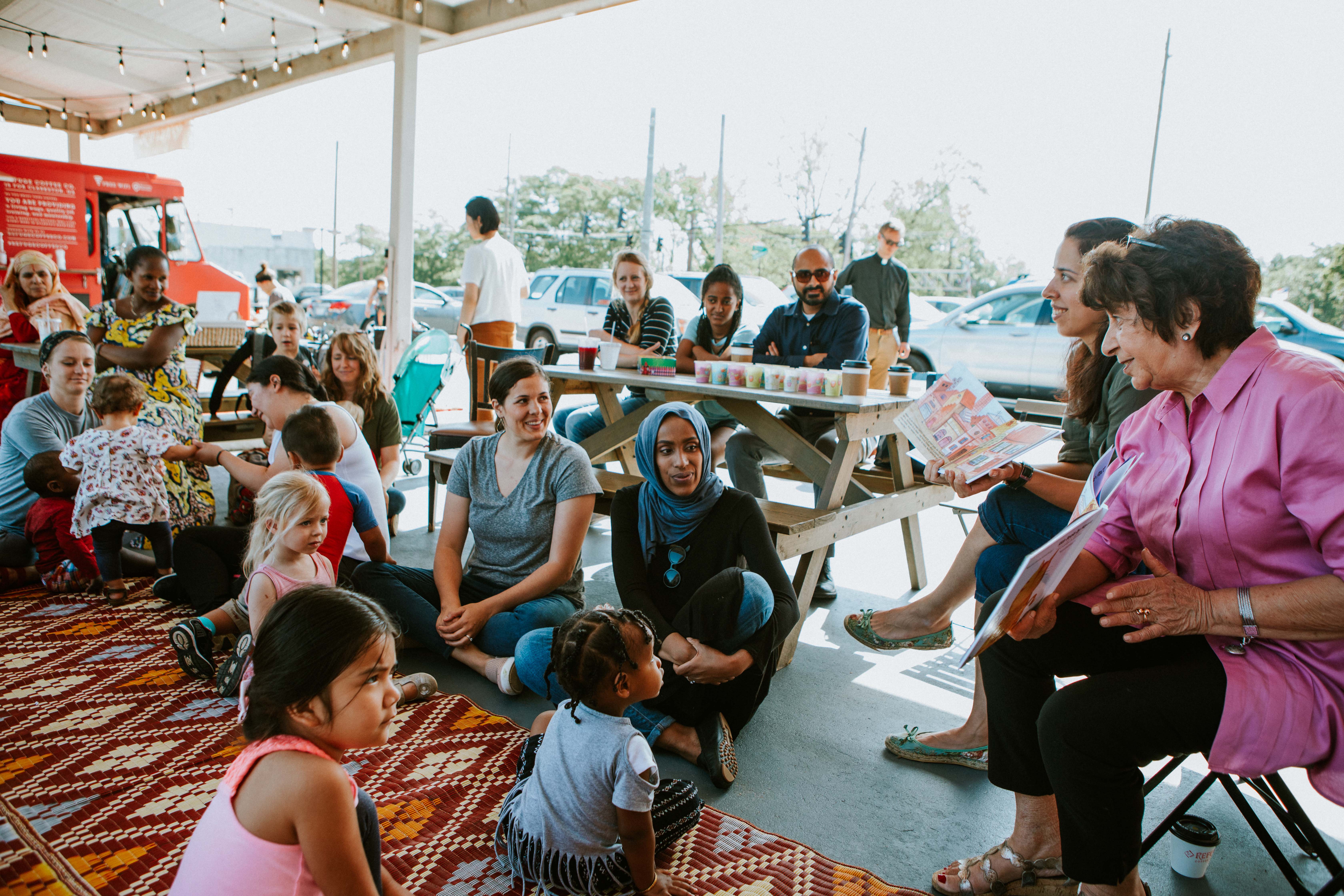 A group of residents gather near Refuge Coffee Co. a coffee and food truck that provides employment and job training to refugees recently resettled in the community of Clarkston, Ga.