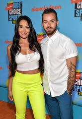 Nikki Bella says fiancé Artem Chigvintsev is happy to be back on "Dancing With the Stars."