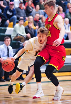 CMR's Bryce Nelson drives to the basket as Hellgate's Abe Johnson defends during Friday night's basketball game in the CMR Fieldhouse.