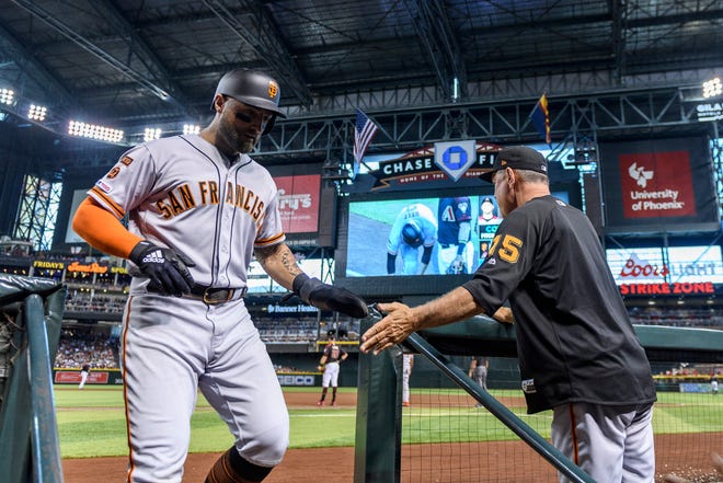 San Francisco Giants center fielder Kevin Pillar (1) is congratulated by manager Bruce Bochy (15) after scoring against the Arizona Diamondbacks in the third inning at Chase Field. Could Pillar be on the Diamondbacks in 2020?