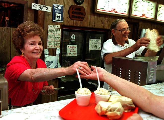 Sue and the late Joe Cobb prepare food for a customer in this 1999 Times file photo. The business recently closed after 67 years in operation.