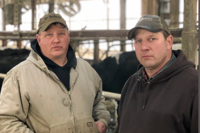 This Dec. 6, 2019 photo shows Craig Gjerde, left, and Paul Gjerde at the hub of the Gjerde brothers enterprise in Sunburg, Minn. Paul Gjerde's dairy farm near Sunburg in west-central Minnesota, is where many dairy farmers, navigate a tight labor market. They have found a source of workers in the Latino community.