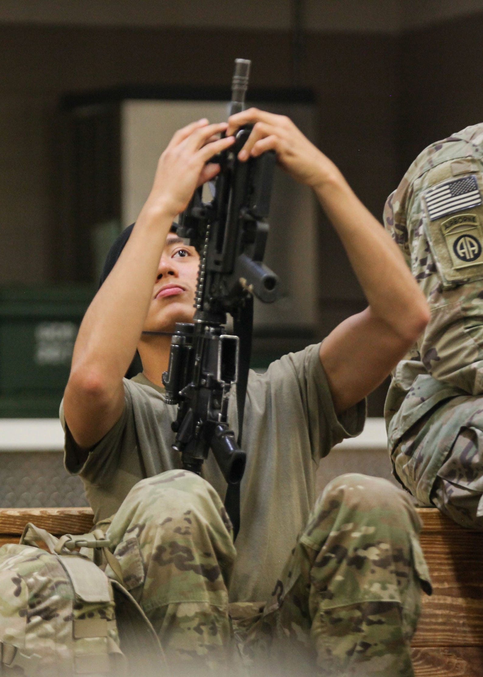 An 82nd Airborne paratrooper bound for the US Central Command area of operations checks his weapon.