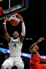 Xavier Musketeers forward Tyrique Jones (4) throws down a dunk in the first half of the NCAA Big East game between the Xavier Musketeers and the St. John's Red Storm at the Cintas Center in Cincinnati on Sunday, Jan. 5, 2020. Xavier led 34-32 at halftime. 