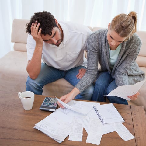Depressed couple doing their accounting in their l