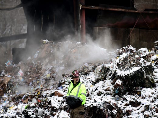 Capt. Jason Henderson of the Apalachin Fire Department looks over the scene at Taylor Garbage's recycling plant in  Apalachin on Monday morning. A fire broke out at the recycling center on Friday evening and continued to burn throughout the weekend. Monday, January 6, 2019. 
