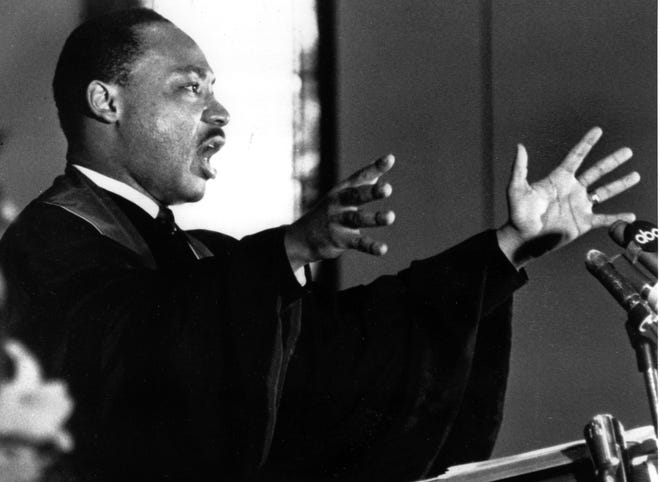 The Rev. Dr. Martin Luther King Jr. gestures to his congregation in Ebenezer Baptist Church in Atlanta, Ga. on April 30, 1967 as he urges America to repent and abandon what he called its "Tragic, reckless adventure in Vietnam."