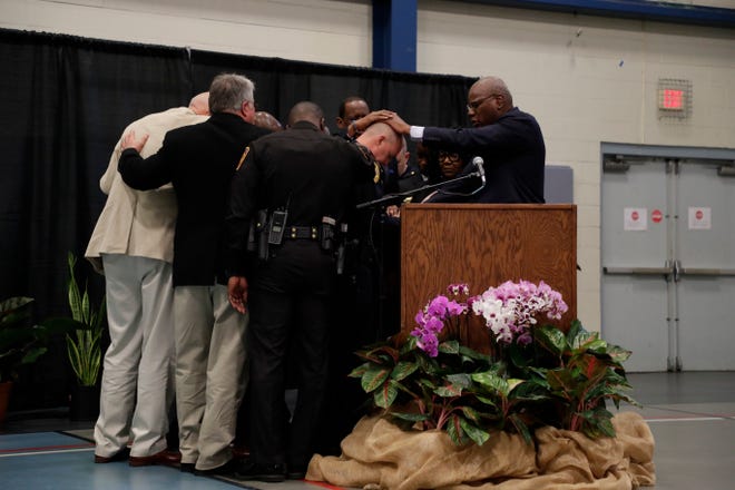 Local clergy pray over newly-appointed Tallahassee Police Chief Lawrence Revell at his swearing-in ceremony at Jack McLean Community Center Monday, Jan. 6, 2020. 