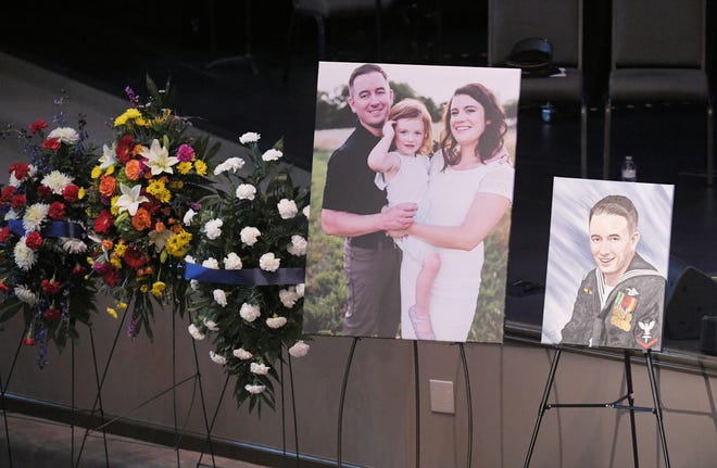 Family photos and a painting are on display near the casket of Hendersonville Master Patrol Officer Spencer Bristol at First Baptist Church Hendersonville on Tuesday, Jan. 7, 2020.