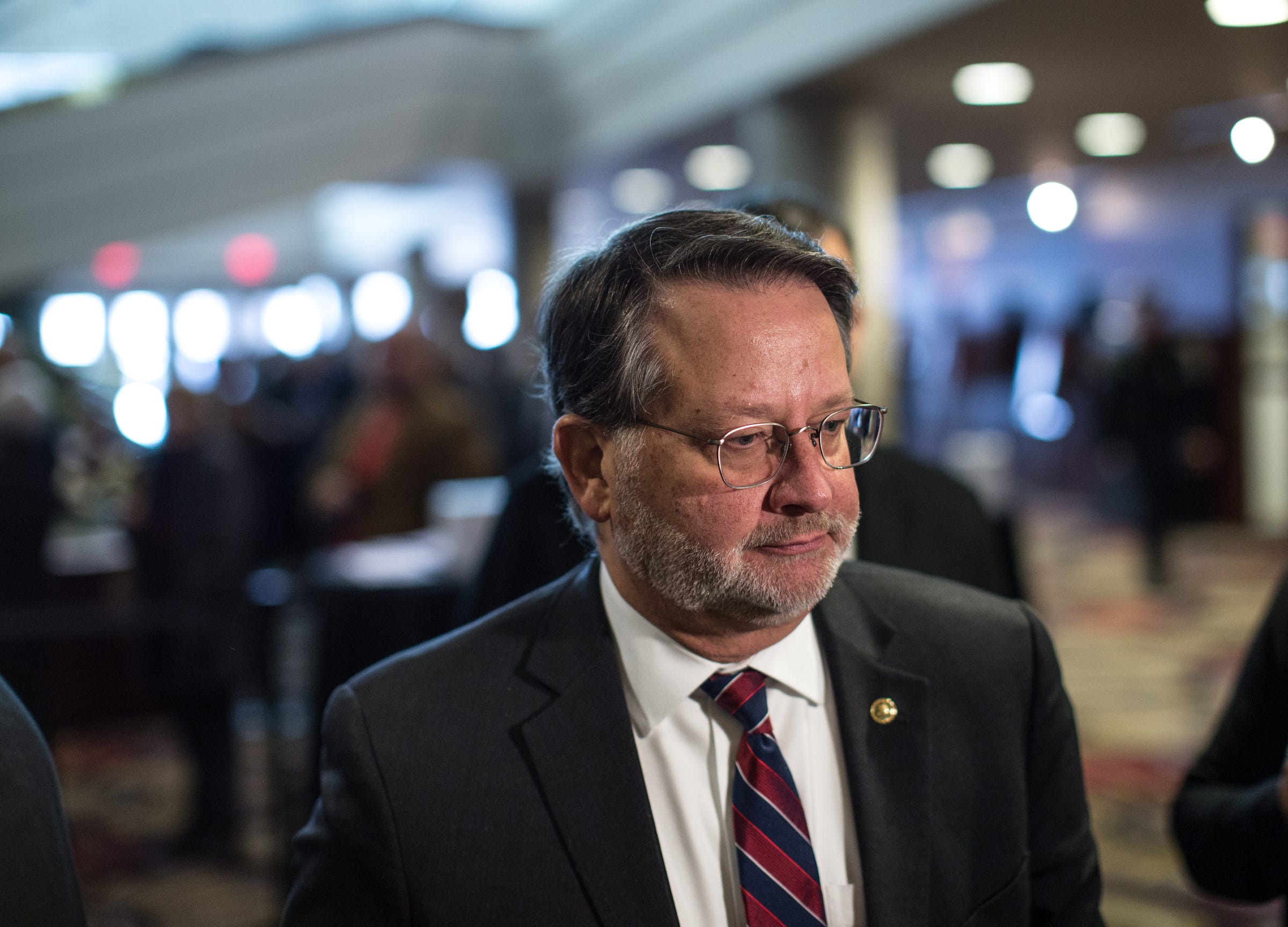 U.S. Senator Gary Peters talks with media during visitation of former US Representative John D. Dingell at the Ford Community and Performing Arts Center in Dearborn on Monday, February 11, 2019.