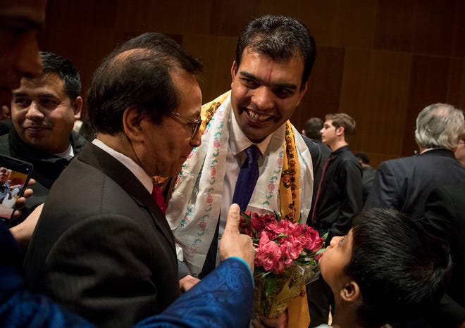 Bhuwan Pyakurel shakes the hands of friends, family members and supporters after being sworn into office on Reynoldsburg City Council. Pyakurel is considered to be the first Nepali-Bhutanese person elected to office in the United States.