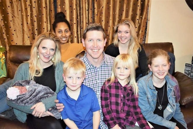 Joseph LeTourneau, who is in the congressional primary for the North State's District 1, sits with his wife Destiny, newborn Halle, daughter Ayni in the top left, Mercy in the top right, and in the front, William, Aliyah and Galilee. Missing is eldest daughter, Anna, who is away finishing college.