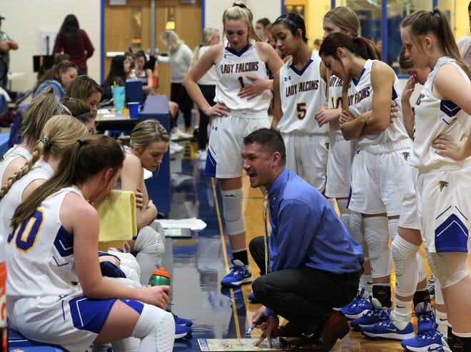 Veribest High School head coach Chris Schlicke goes over strategy with the Lady Falcons during a home game against Bronte on Tuesday, Jan. 7, 2020.