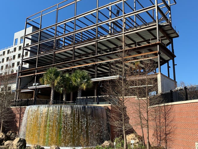 The view of the waterfall at Cascades Park now includes scaffolding that will become part of the Cascades Project.