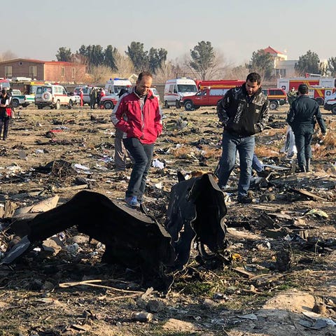 People walk near the wreckage after a Ukrainian pl