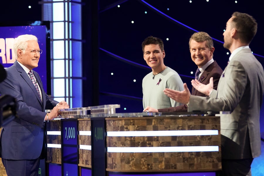 Alex Trebek interacts with "Jeopardy!" legends (from left to right): James Holzhauer, Ken Jennings and Brad Rutter.
