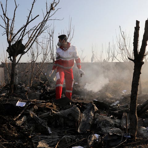 A rescue worker searches the scene where an Ukrain