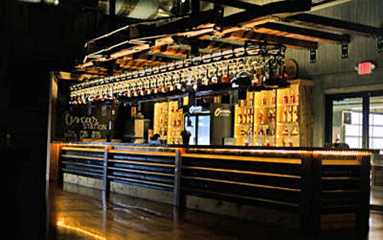 An overhead conveyor belt system stores 45 of the top spirits at the bourbon bar at the Oscar Station.
