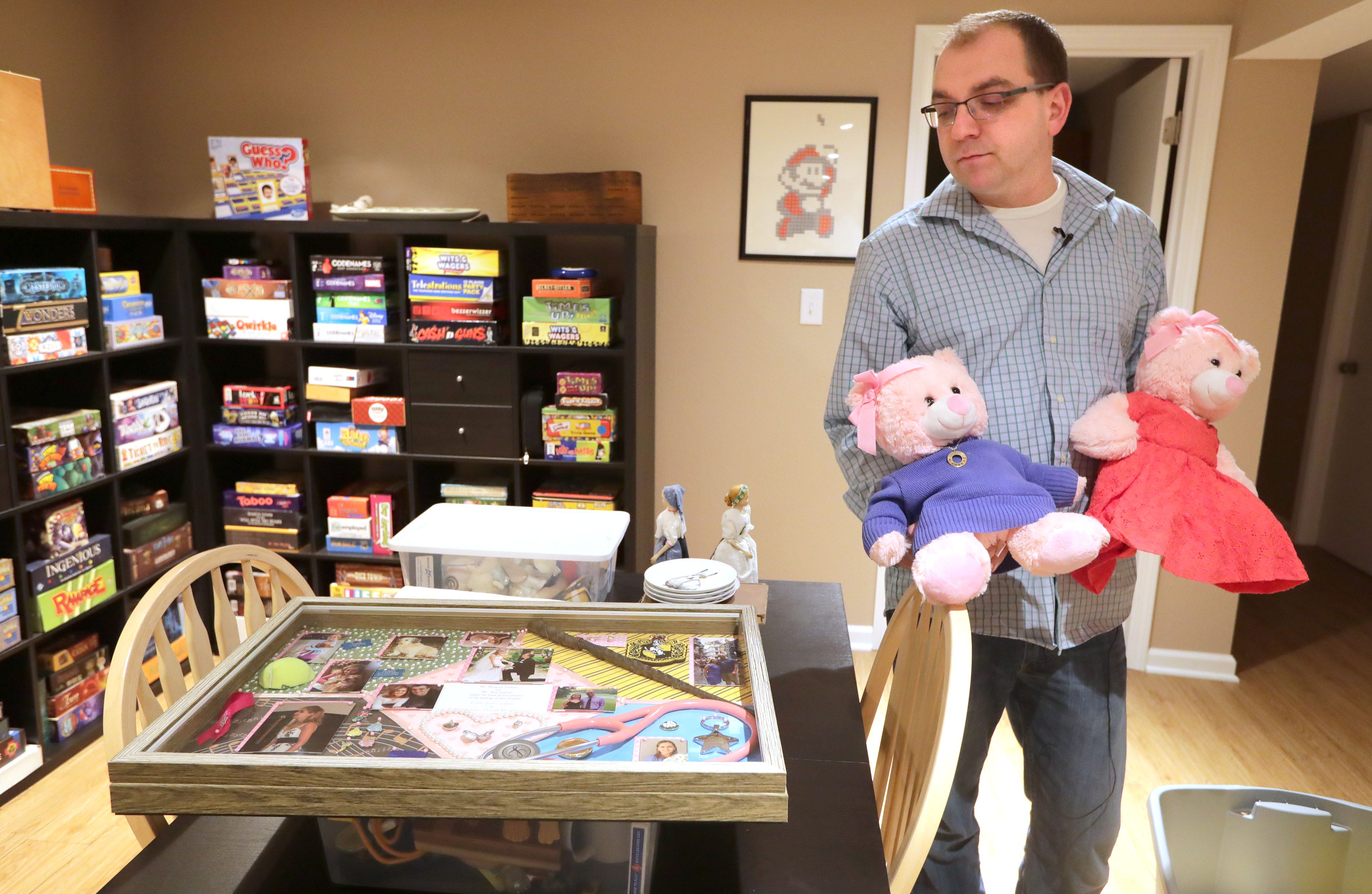 Nick Beaudin, husband of Carlie Beaudin, the Froedtert nurse practitioner who was beaten to death in Froedtert Hospital'sÂ parking garage, holds a couple of teddy bears with outfits made from the clothes of his wife as he looks at a framed collection of photos and memorabilia of Carlie. Nick had several of Carlie outfits made to fit the teddy bears he called Carlie Bears and gave them to family and friends. He's pictured in his home in Greendale on Wednesday, Jan. 8, 2020.   Photo by Mike De Sisti / Milwaukee Journal Sentinel