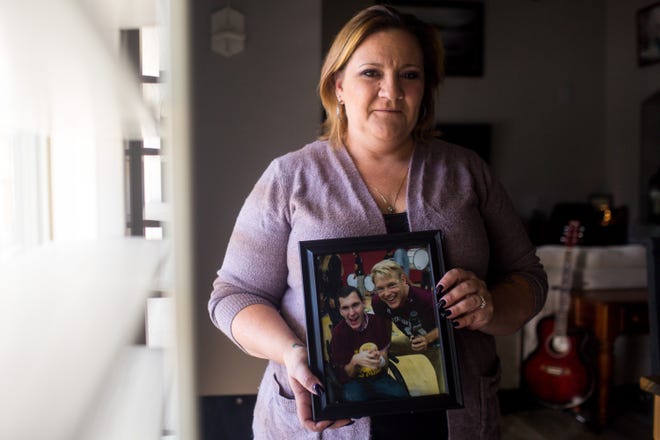 Tonia Rokeby poses for a portrait with a photograph of her late son Darien McCulley (right) on Nov. 8, 2019. McCulley had cerebral palsy, and died of sepsis at the age of 19.