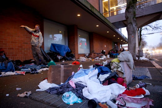 People start to clear belongings on the sidewalk outside the former Nordstrom before crews come in to clean the area in downtown Salem on Jan. 9, 2020. People experiencing homelessness have been staying outside the former Nordstrom and the Rite Aid downtown for about two weeks.