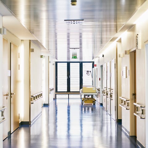 Hospital with corridor and bed without persons in 