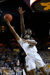 Michigan guard Zavier Simpson (3) shoots in front of Purdue forward Trevion Williams during the second half.