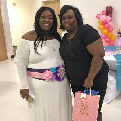 Tashonna Ward poses at her baby shower with her mo