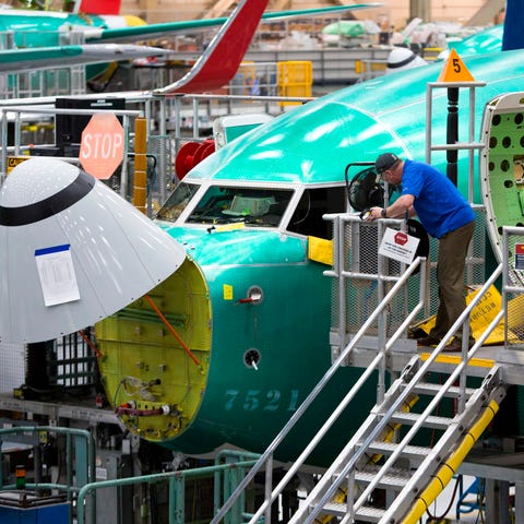 Employees work on Boeing 737 MAX airplanes at the 