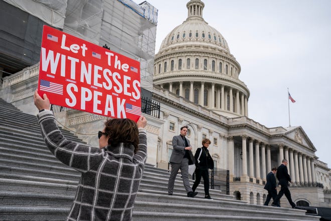 Laura Albinson of Pasadena, Md., displays a message at the Capitol in Washington, DC on Jan. 10, 2020.