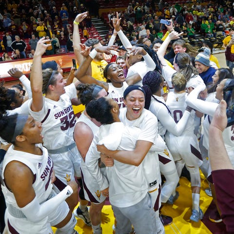 Arizona State fans storm the court to celebrate th