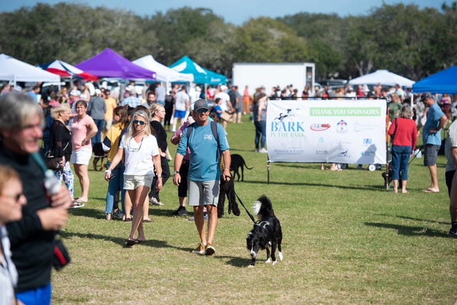 A proposed ordinance would clarify where leashed dogs can walk with their owners, including at some beach areas. In this photo taken Jan. 11, 2020, Holli Kozar (left) and Jim Kozar walk with Opie, a border collie, at the seventh annual Bark in the Park at Riverside Park in Vero Beach.