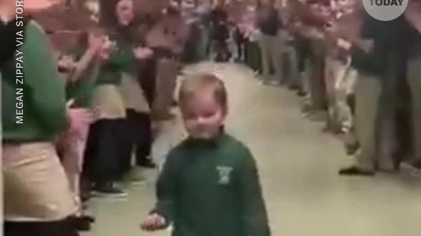 6-year-old receives a standing ovation after finis