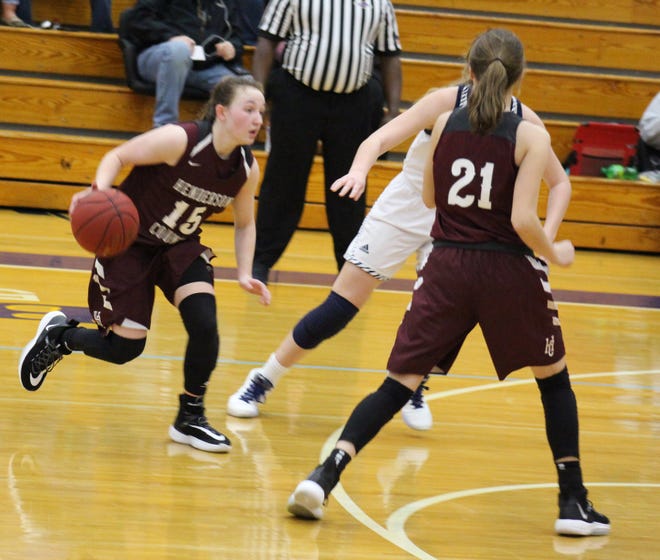 Henderson County's Sadie Wurth drives toward the basket as teammate Graci Risley sets a screen during Saturday's game against Elizabethtown in the Bluegrass Cellular New Year's Classic at Central Hardin High School.