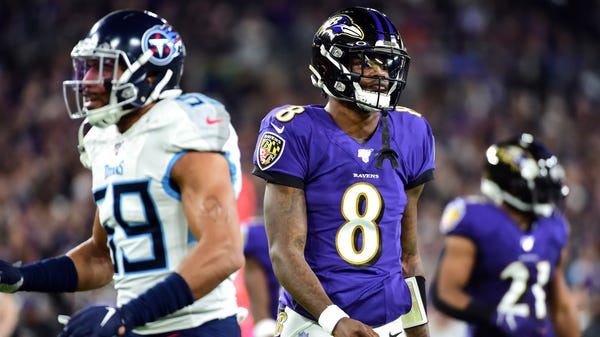 Baltimore Ravens quarterback Lamar Jackson (8) wal