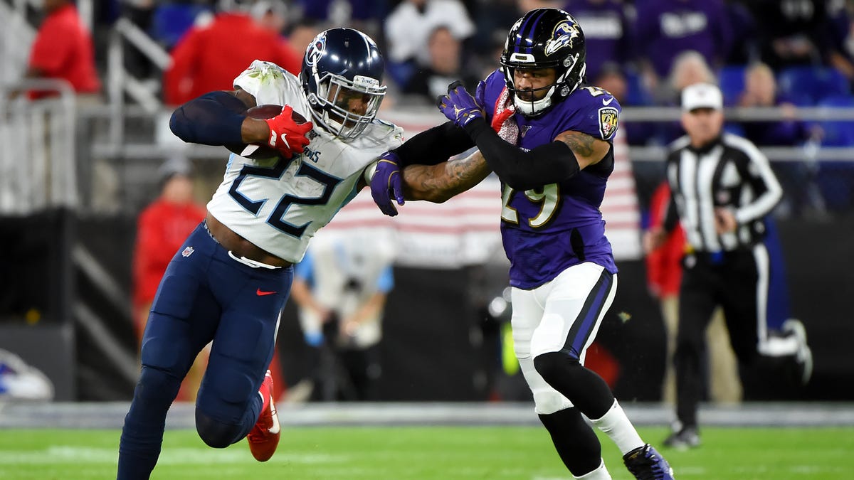 Derrick Henry of the Tennessee Titans carries the ball against Earl Thomas of the Baltimore Ravens during the AFC Divisional Playoff game at M&T Bank Stadium on January 11, 2020 in Baltimore, Maryland.