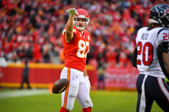 Kansas City Chiefs tight end Travis Kelce (87) celebrates a first down against the Houston Texans during the second quarter in a AFC Divisional Round playoff football game at Arrowhead Stadium.