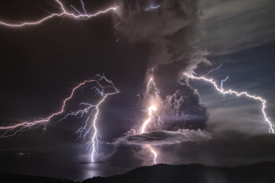 Lightning strikes as a column of ash surrounds the crater of Taal Volcano as it erupts on Jan. 12, 2020 as seen from Tagaytay city, Cavite province, Philippines. 