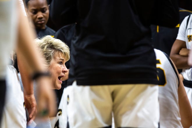 Iowa head coach Lisa Bluder talks with players in a timeout during a NCAA Big Ten Conference women's basketball game, Sunday, Jan. 12, 2020, at Carver-Hawkeye Arena in Iowa City, Iowa.