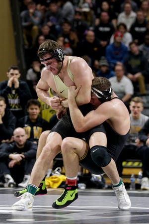 Purdue's Christian Brunner wrestles Iowa's Jacob Warner during a 197 pound bout in a Big Ten dual wrestling match, Sunday, Jan. 12, 2020 at Holloway Gymnasium in West Lafayette.