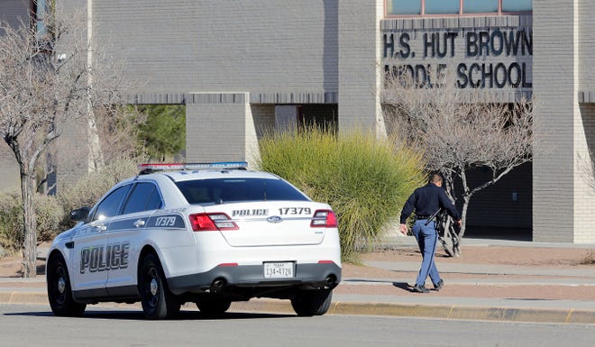 An El Paso Independent School District police officer walks toward Brown Middle School on Monday, Jan. 13, 2020, after threats were made to the campus over the weekend. The district determined the threat was not credible.