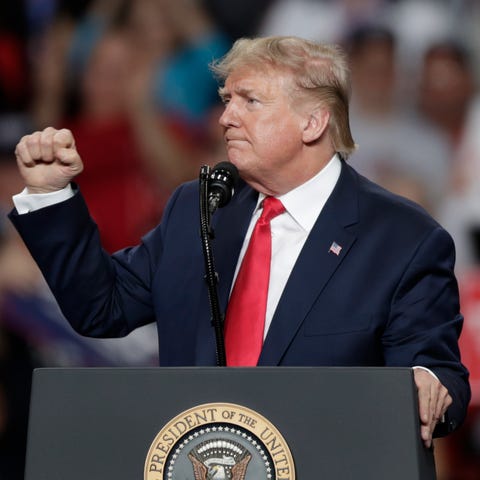 President Donald Trump pumps his fist after speaki