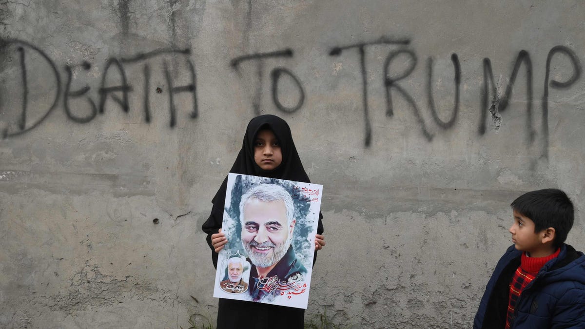 A young girl holds a poster of Iranian commander Qasem Soleimani as she takes part in a anti-US protest against the killing of the top Iranian commander, in Iraq, on Jan. 12, 2020.