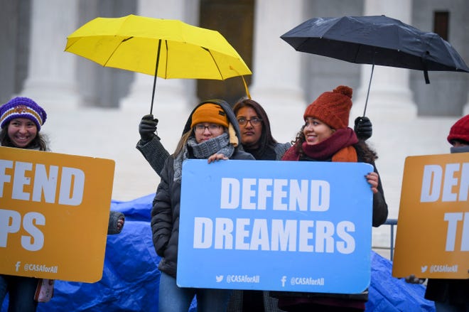 Demonstrators stand in the cold and rain outside the Supreme Court in November during oral argument on the Trump administration's decision to end the Deferred Action for Childhood Arrivals (DACA) program.